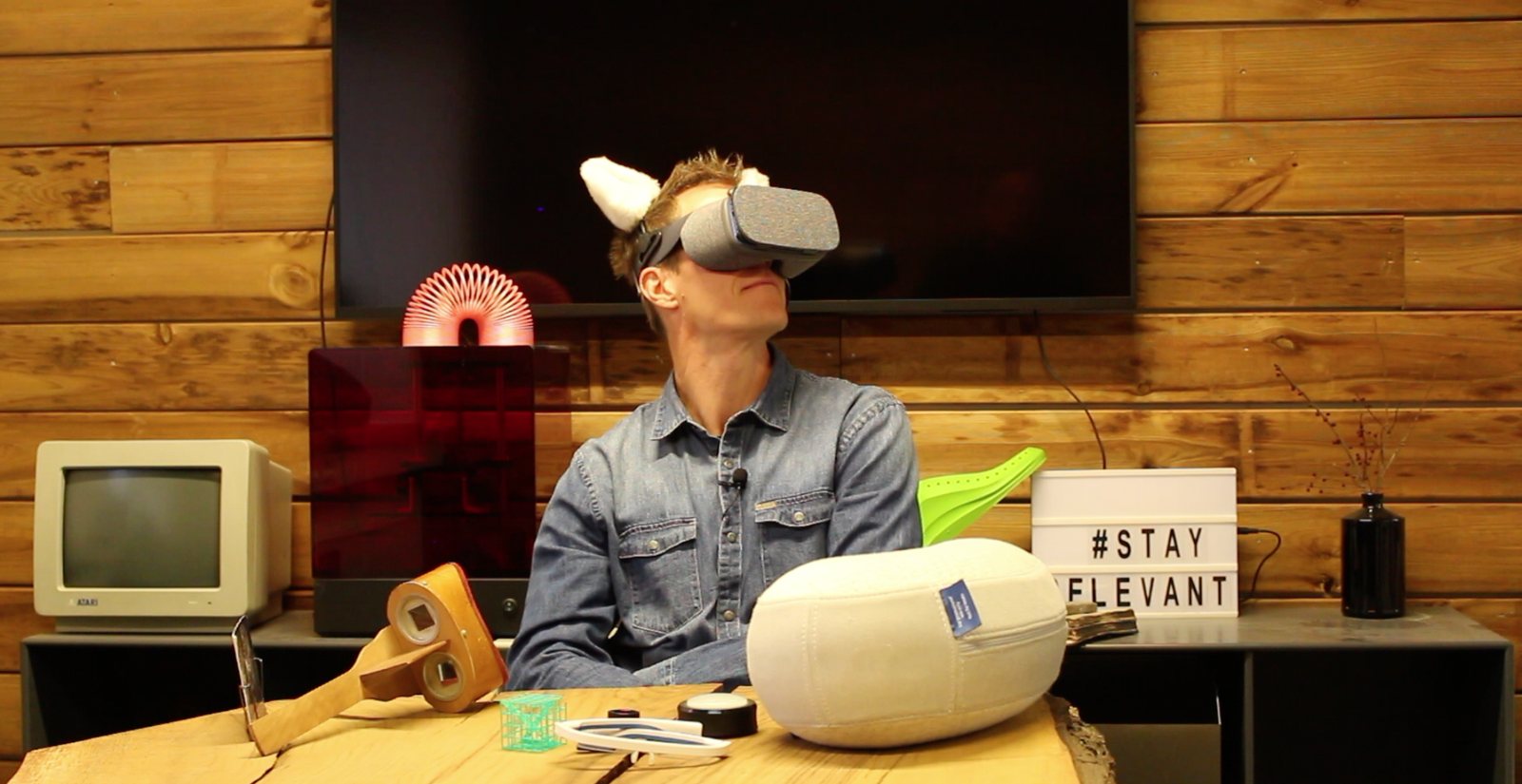 Jarle Kondrup wearing VR goggles among technology and gadgets in Innovation Lab's demo lab